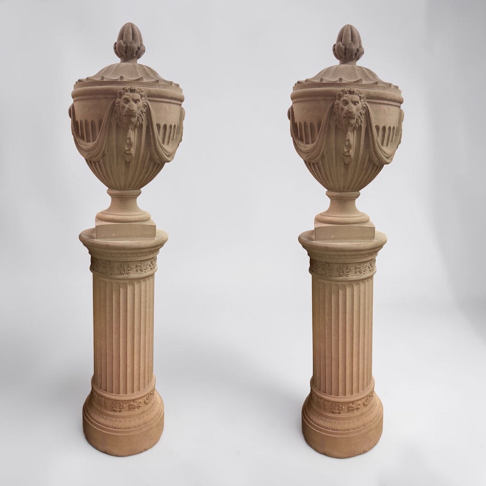Neoclassical Lion Head Urns on Pedestals