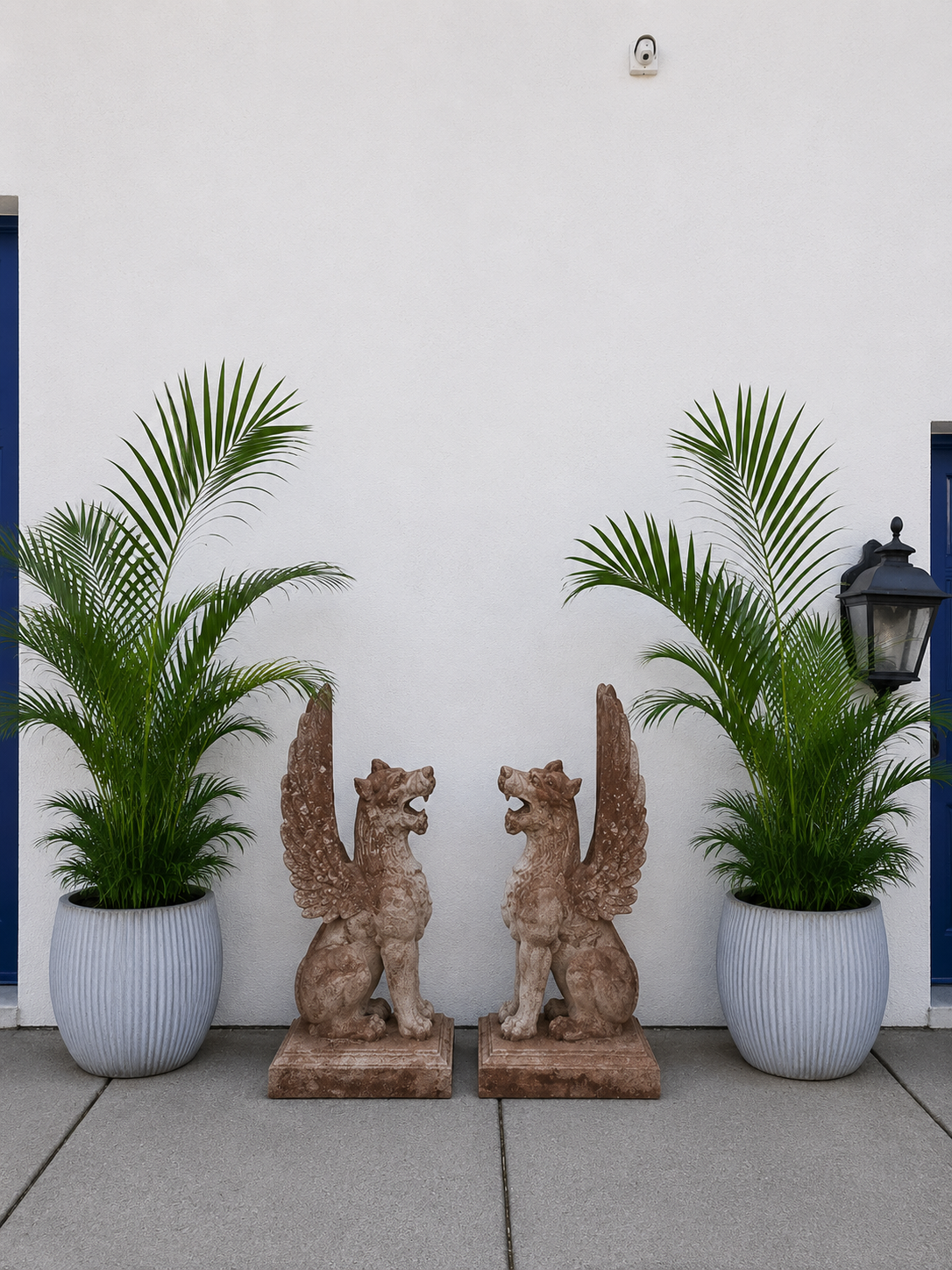 Pair of Monumental Neoclassical Cast Iron Winged Griffin Statues